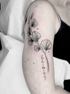 Admire the intricate details of this illustrative tattoo featuring a beautiful flower, leaf, and plant design by the talented artist Beyza Taser.