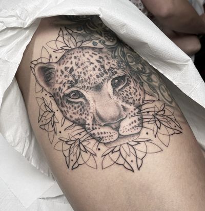 Embrace your wild side with this ornamental tattoo featuring a stunning leopard pattern. By tattoo artist Beyza Taser.