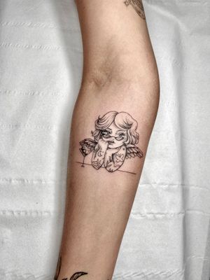 Illustrative tattoo by Beyza Taser featuring a delicate angel doll holding a martini drink.
