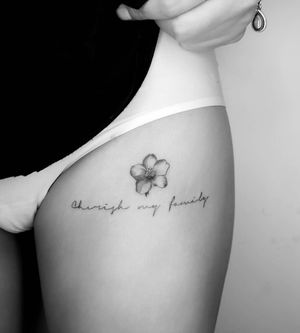 Graceful fine line and small lettering design of a flower done by the talented artist Math. Perfect for those wanting a subtle yet beautiful tattoo.