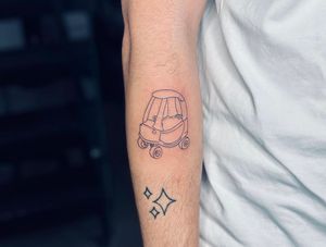 Fine line and illustrative tattoo by Tal featuring a whimsical design of kids playing with a toy car. Perfect for those with a love for childhood memories.