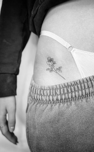 Get a beautifully detailed rose tattoo in fine line style by the talented artist Math. Perfect for those who appreciate delicate and intricate designs.