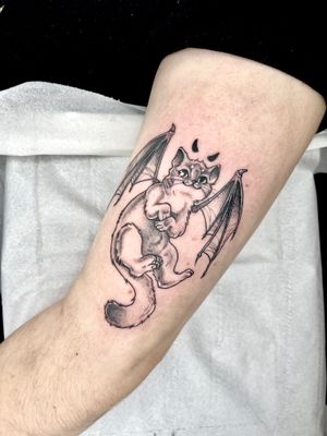 Discover the mystique of this beautiful black and gray cat tattoo, expertly rendered in a sketch-like illustrative style by Beyza Taser.