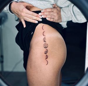 Experience the beauty of the moon's cycles with this black and gray illustrative tattoo by Tal. A unique and captivating design.