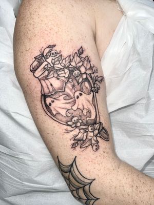 Illustrative dotwork tattoo featuring a ghost, potion, and bottle, created by tattoo artist Beyza Taser.