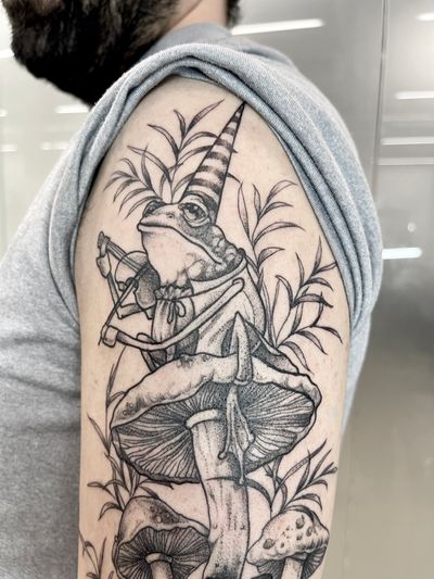 Unique blackwork tattoo by Beyza Taser featuring a frog, music notes, and a mushroom in illustrative dotwork style.