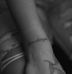 Get a beautiful and minimalist lettering tattoo by Meg. Perfect for those looking for a subtle yet meaningful design.