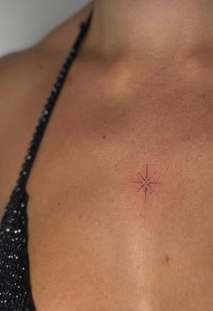 Get a dainty and elegant fine line star tattoo by Meg. Perfect for those looking for a subtle and minimalist design.