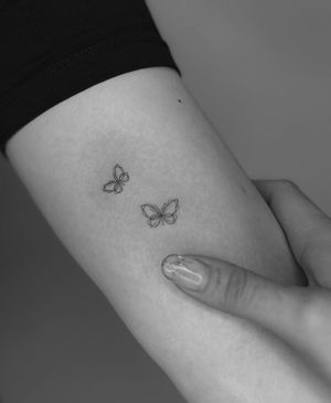 Embrace beauty and grace with this delicate butterfly tattoo, expertly crafted with fine lines by the talented artist Meg.