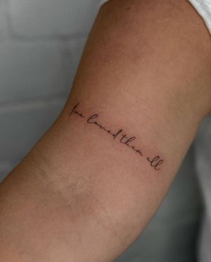 Get a beautifully crafted fine line tattoo with small lettering by the talented artist Meg. Perfect for a subtle and elegant look.