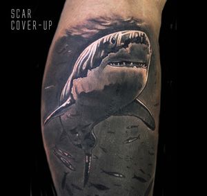 Dive into the depths with this stunning black and gray shark tattoo by artist Craig Hicks. Capturing the power of the ocean in stunning detail.