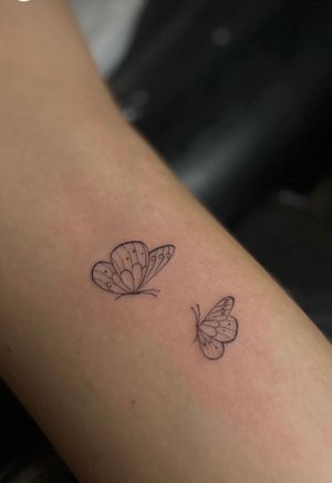 Transform your skin with a delicate fine line butterfly design by the talented artist Meg. Embrace grace and beauty with this exquisite tattoo.