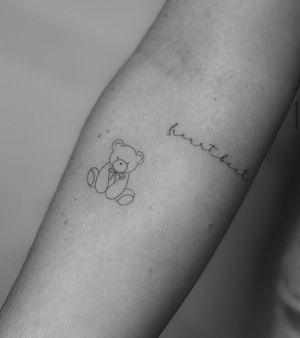 Fine line and illustrative tattoo of a cute teddy bear toy, perfect for anyone who loves childhood memories. Designed by Meg.