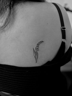 A beautiful illustrative tattoo featuring a delicate bellflower, expertly done by tattoo artist Ruth Hall.