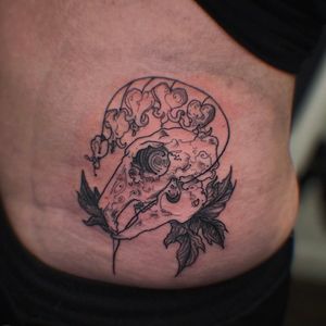 Beautiful illustrative tattoo featuring a flower, skull, bellflower, and leaf motif by tattoo artist Holly Valley.