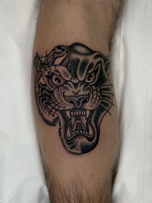 Get a fierce yet classic look with this traditional style tattoo of a panther and tiger by the talented artist Barney Coles.