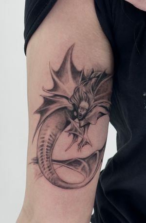 Intriguing black and gray mermaid tattoo by Saka Tattoo, capturing the allure and mystery of the sea monster.