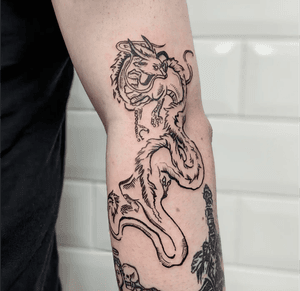 Illustrative dragon tattoo by Adam McDade with medieval woodcut design.