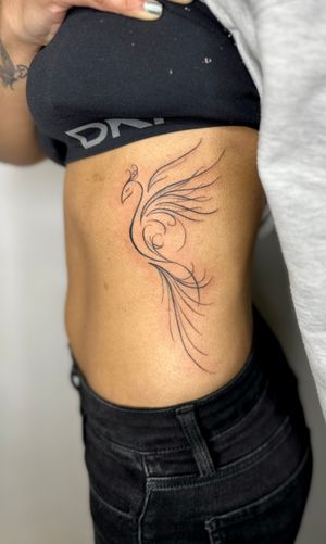 Beautiful illustrative hand-poked phoenix tattoo done by talented artist jadeshaw_tattoos, bringing the mythical bird to life through intricate linework.