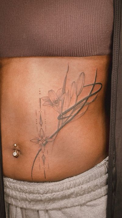 abstract Lily and ornamental tattoo on the stomach
