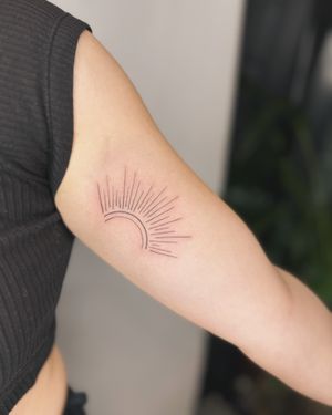 Admire the intricate beauty of the delicate sun motif in this stunning fine line tattoo by jadeshaw_tattoos.