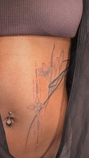 abstract Lily and ornamental tattoo on the stomach