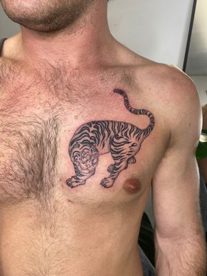 Get a fierce and striking Japanese tiger tattoo by the skilled artist Charlie Macarthur. This illustrative design will make a bold statement on your skin.