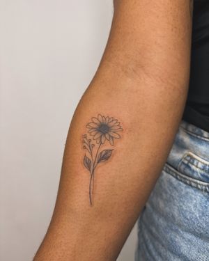 Admire the delicate beauty of this illustrative flower tattoo on dark skin. Created by the talented artist jadeshaw_tattoos.
