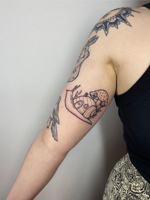 Unique illustrative tattoo by Joanna Webb featuring a snail and a cozy house design.
