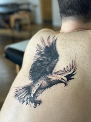 Capture the power and grace of the eagle with this illustrative black and gray tattoo by Saka Tattoo.