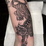 Embrace the power and beauty of the traditional Japanese tiger motif in this captivating tattoo by renowned artist Barney Coles.