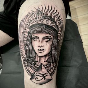 Experience the beauty of Cleopatra surrounded by Egyptian motifs and pyramids in this stunning tattoo by Sam Waiting.