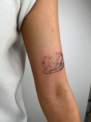 Elegant swan design by Emma InkBaby, featuring detailed illustrative style for a stunning and unique tattoo.