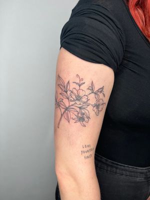 Unique tattoo design of a passion flower and branched by Emma InkBaby, combining elegance and nature in one beautiful piece.