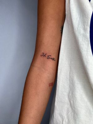 Elegant and delicate fine line tattoo featuring small lettering, created by the skilled artist Emma InkBaby.