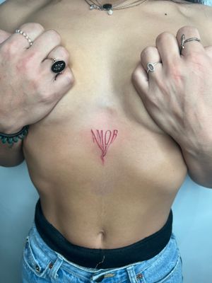 Get a unique and edgy tattoo with small glitchy lettering by talented artist Emma InkBaby. Perfect for a subtle yet impactful design.
