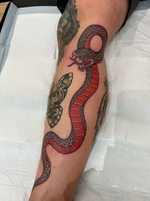 Get a bold and classic illustrative snake tattoo by the talented artist Sam Waiting. Embrace the power and symbolism of the snake with this timeless design.