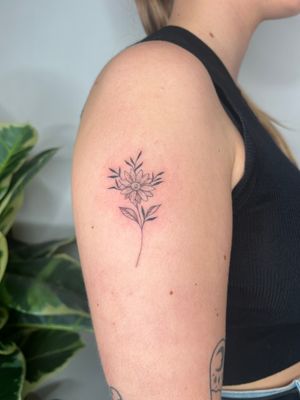 Get inked with a delicate and intricate flower design by Emma InkBaby, combining fine line work and illustrative style.