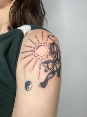 Get a fierce combination of the sun and panther in this unique illustrative tattoo by Emma InkBaby.