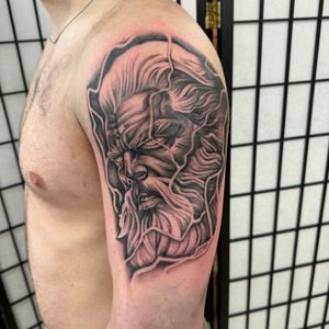 Capture the power of Zeus with this striking black and gray illustrative tattoo by talented artist Sam Waiting.