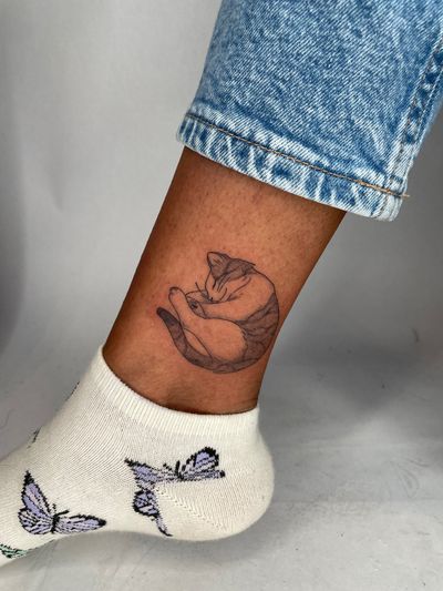 Get a cute and playful illustrative tattoo of your beloved pet cat by the talented artist Emma InkBaby. Show off your love for felines with this unique design.