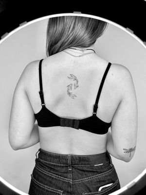 Transform your skin with this elegant fine_line and illustrative koi fish tattoo, expertly crafted by the talented artist Ruth Hall.