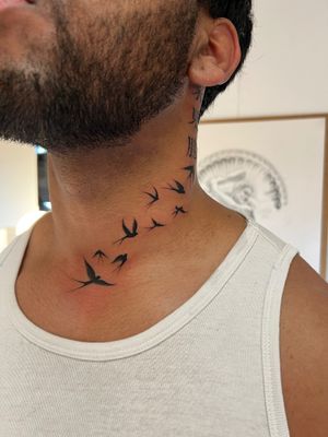 Detailed illustrative blackwork tattoo of a swallow bird by Ion Caraman, featuring intricate linework and shading.