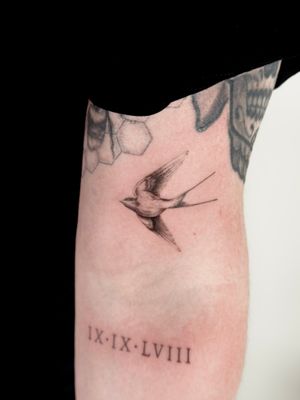 Get a stunning black and gray bird tattoo by Saka Tattoo, featuring a beautiful illustrative swallow design.