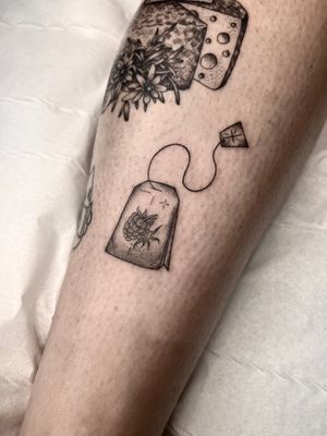 Get a unique dotwork illustrative tattoo of a teabag and tea by the talented artist Claudia Whiteheart.