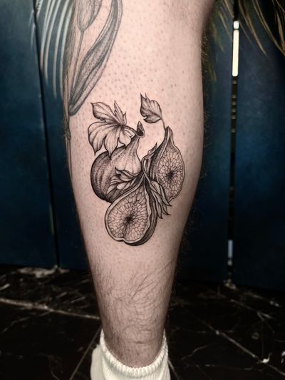 Experience the beauty of nature with this black and gray illustrative fig tattoo by the talented artist Claudia Whiteheart.