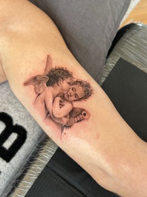 This beautiful black and gray illustrative tattoo by Ion Caraman features a cherub embracing the classic tale of Eros and Psyche. A timeless symbol of love and devotion.