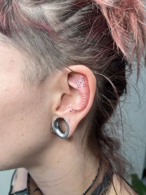 Unique hand-poked dotwork ear design by Marketa.handpoke. Intricate ornamental details for a stunning and original tattoo.