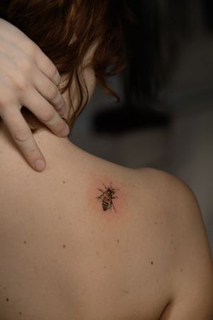 Experience stunning detail and color in this micro realism bee tattoo by artist Viola. Perfect for nature lovers.