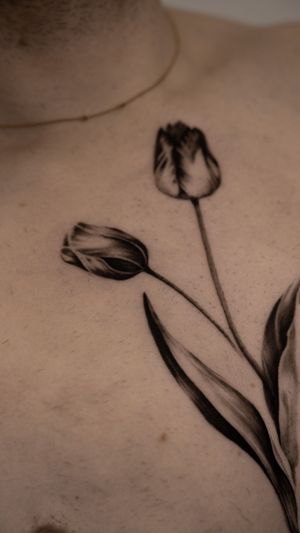 Adorn your skin with Viola's stunning black & gray micro realism peony tattoo for a touch of timeless beauty.